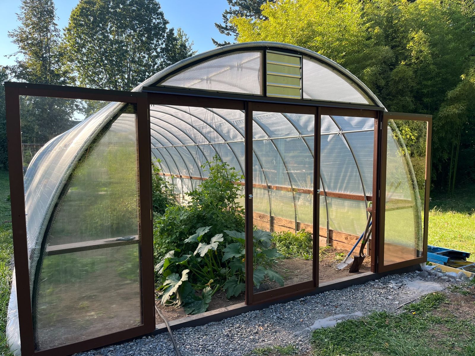 20 foot wide Quonset greenhouse with custom sliding doors supplied by the customer